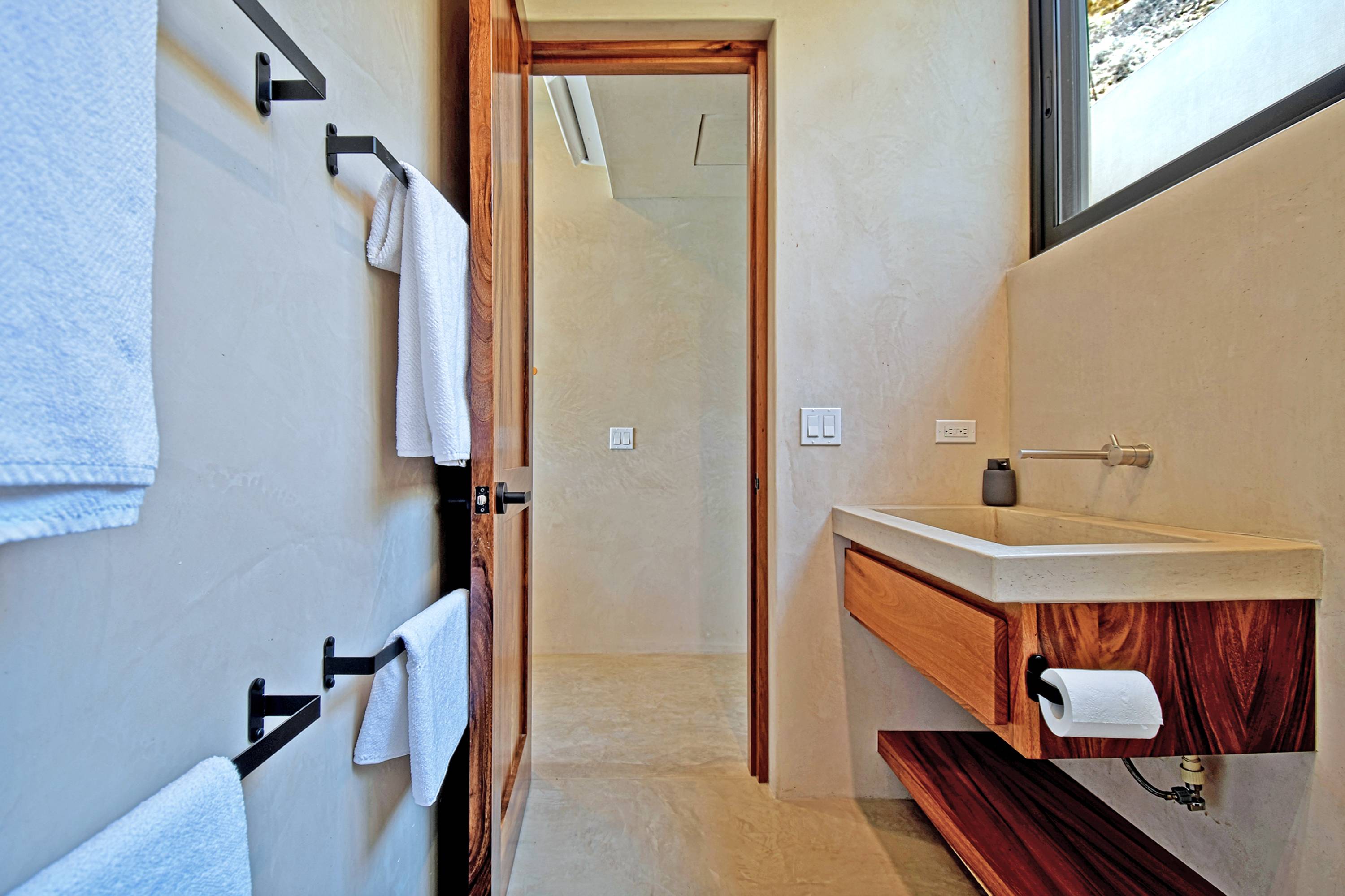 Towels on the rail in the second bedroom's bathroom.