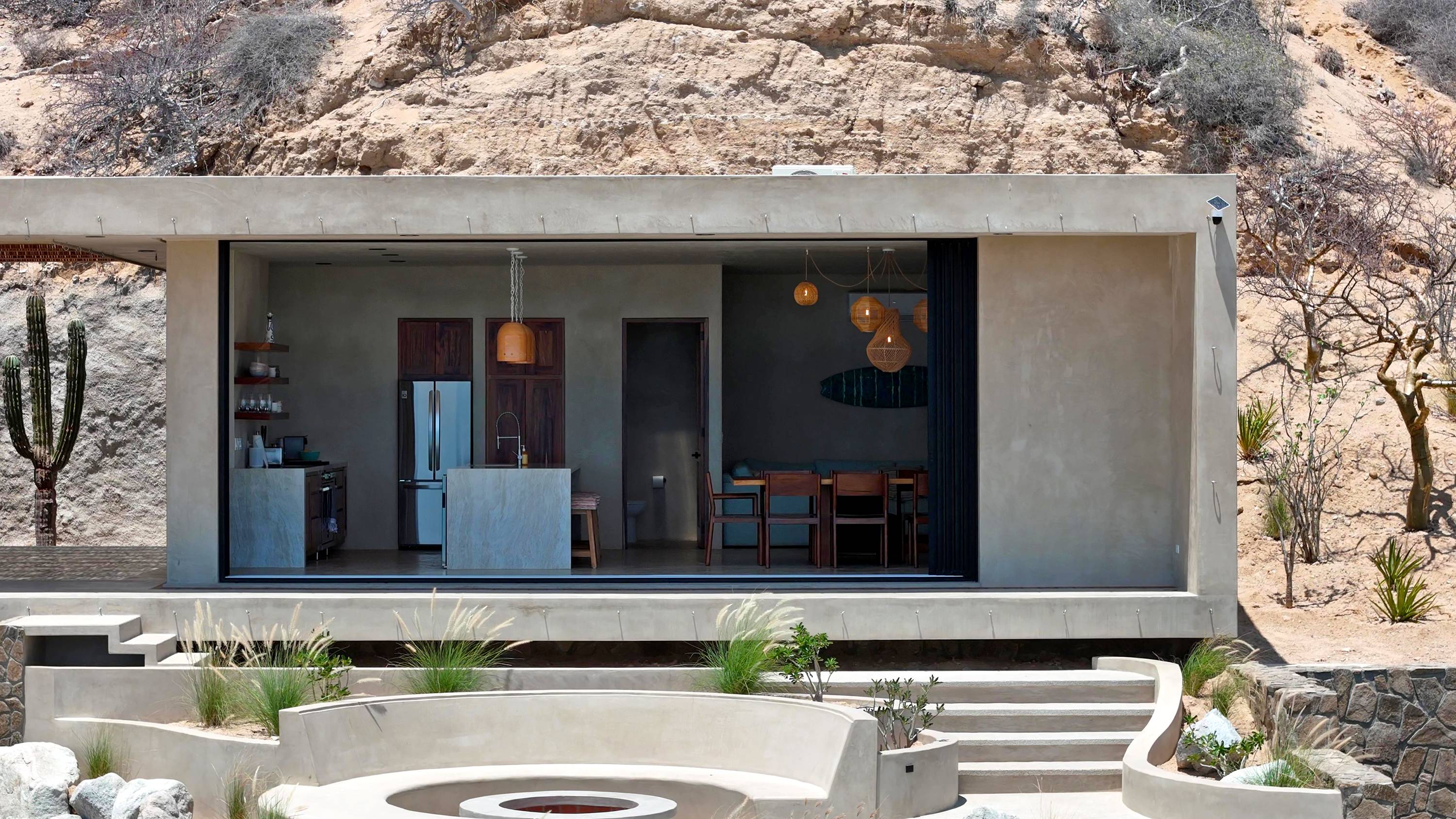 The living side seen from outside, glass front open onto the terrace.