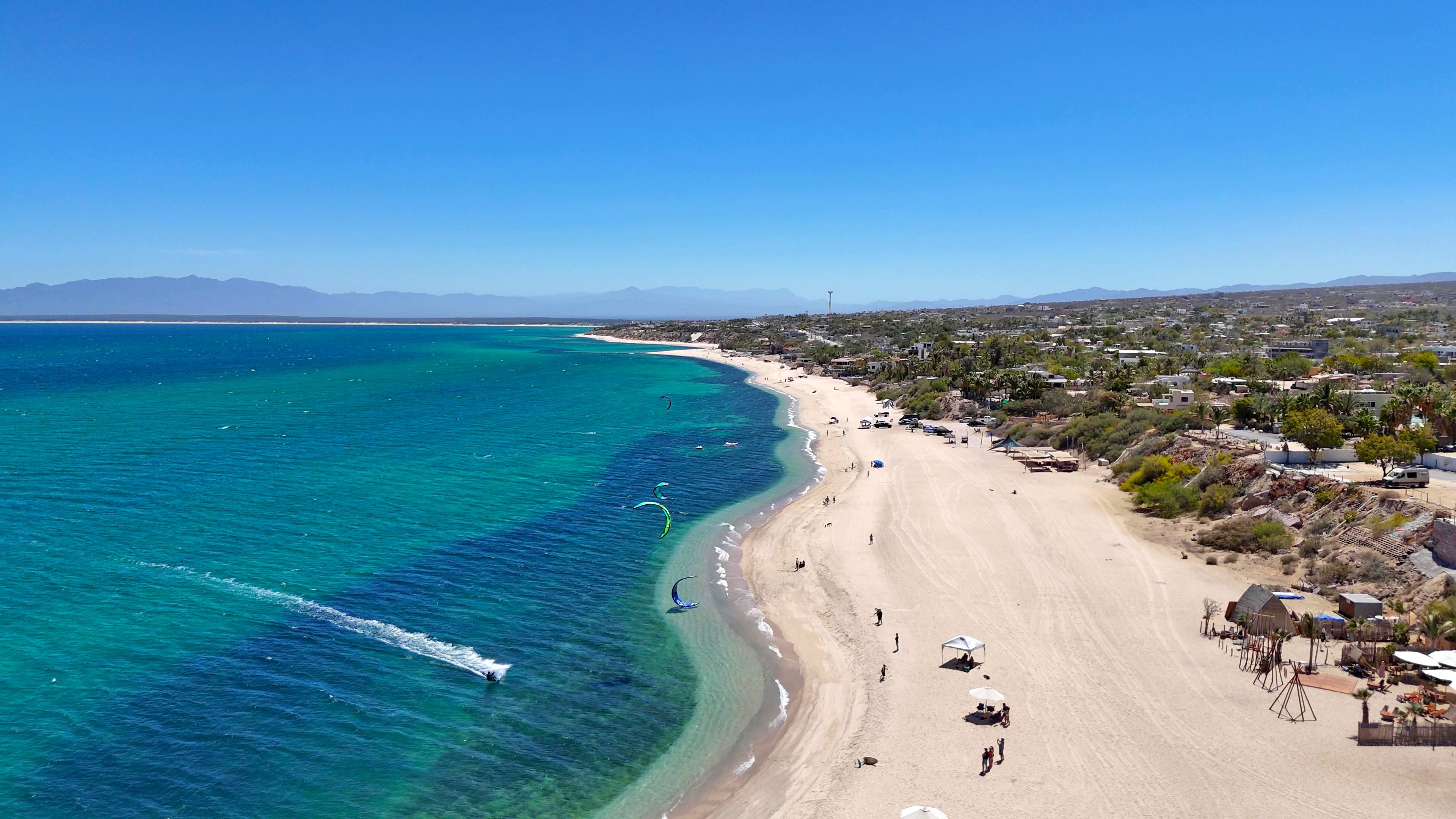 A kiter on the bay off the beach, seen from the air.