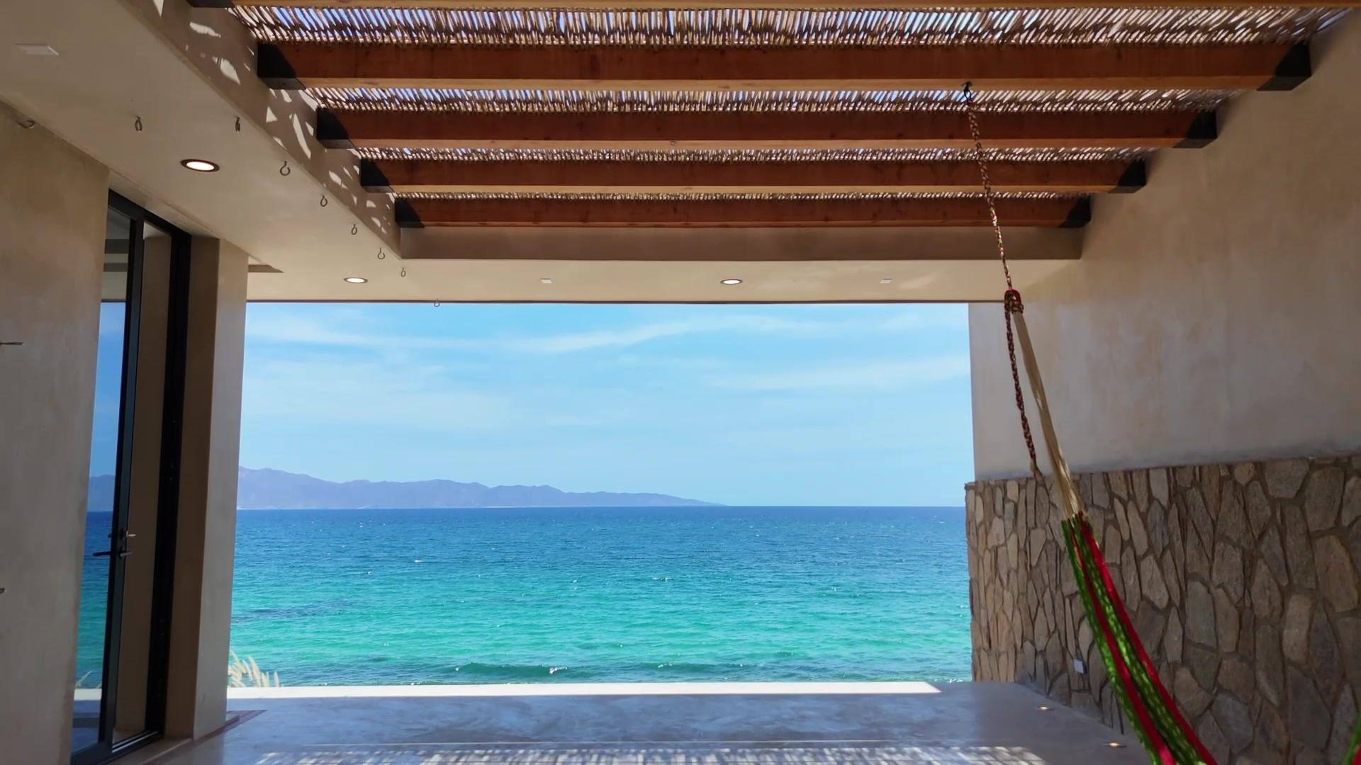 The bay from the covered patio, with a hammock in the corner.