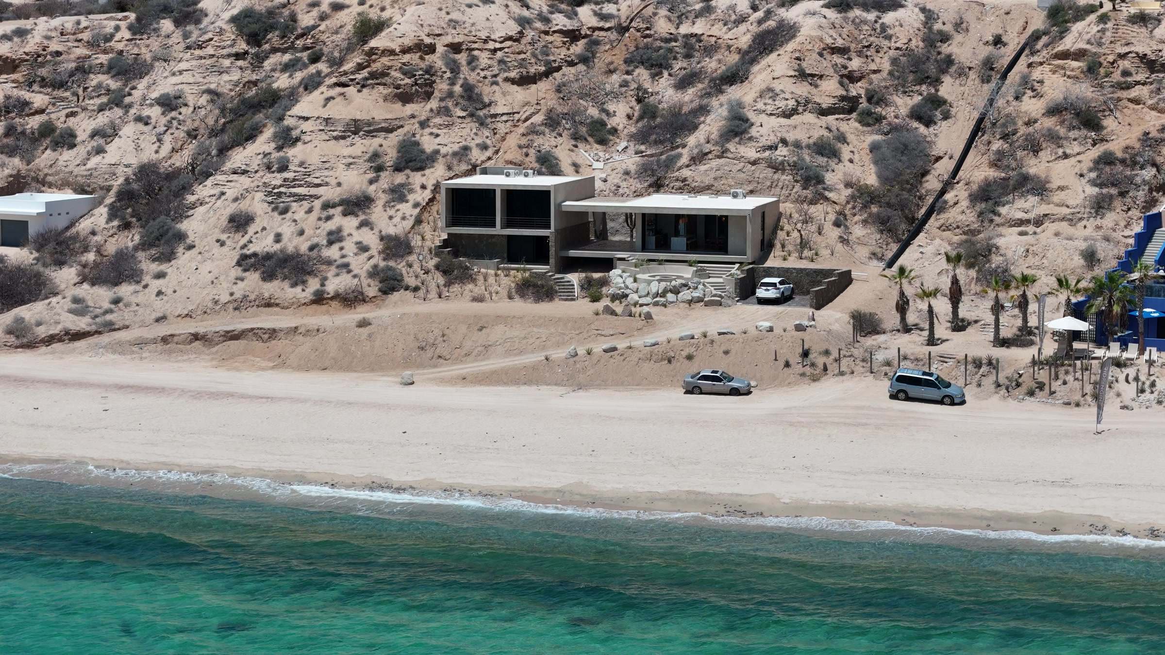 Beach Haus from the air, the beach and the bay in front of it.