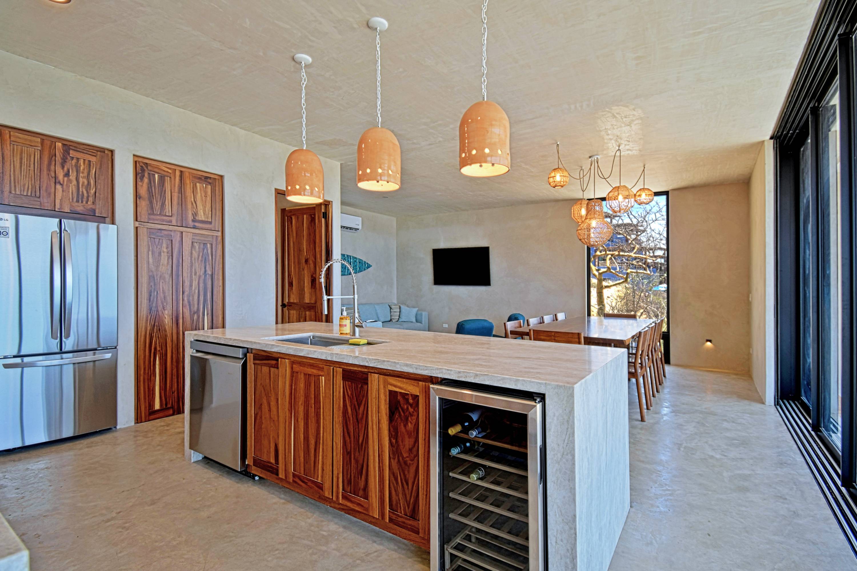 The kitchen island, wine fridge and the TV on the living side.